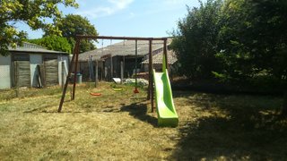 swing set incorporating three swings and a long slide